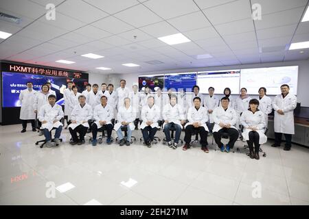 (210219) -- BEIJING, Feb. 19, 2021 (Xinhua) -- Members of the research team of China's Hard X-ray Modulation Telescope (HXMT) pose for a group photo at the Institute of High Energy Physics under the Chinese Academy of Sciences in Beijing, capital of China, Feb. 18, 2021. China's HXMT, the country's space science satellite also known as Insight, has found that a fast radio burst signal detected last year came from a magnetar in the Milky Way, Chinese scientists announced Friday.   The discovery marked a milestone in understanding the nature of the mysterious signal emanating from the universe, Stock Photo