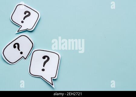 Ask question concept. Question mark on speech bubbles, top view Stock Photo