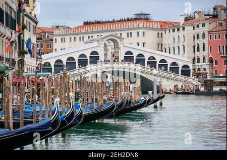 Rialto Bridge and gondolas seen from boat, Venice, Veneto, Italy Stock Photo