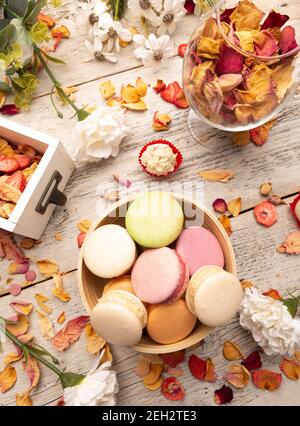 Still life of macaroon cakes in bowl on wooden background Stock Photo