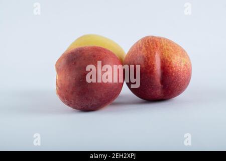 Three fresh nectarines located on white background Stock Photo