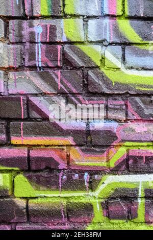 Spray painted brick wall detail Stock Photo