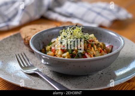 Spring lentil salad with bread. Salad with fresh vegetables and herbs. Healthy food. Stock Photo