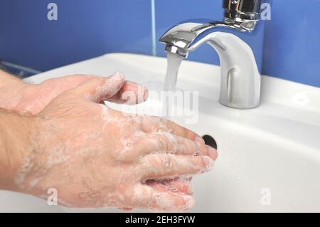 Washing hands with soap under running water Stock Photo - Alamy
