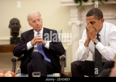 President Barack Obama reacts to a comment during the daily economic briefing in the Oval Office with Vice President Joe Biden on July 30, 2009. Stock Photo