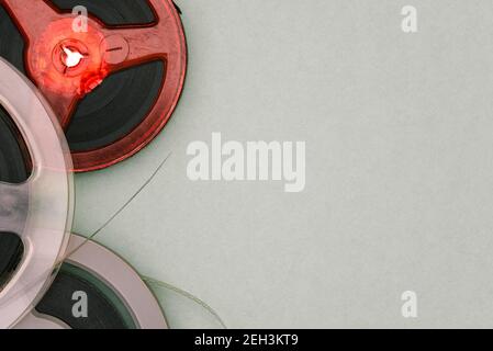 Old film reels on a green background with copy space. Magnetic tape. Top view, flat lay. Stock Photo