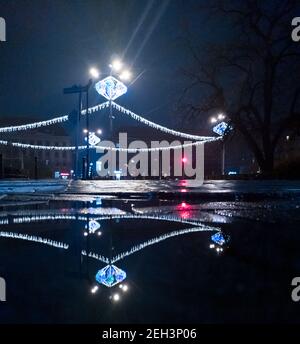 Wroclaw December 22 2019 Christmas decorations over Kosciuszki square reflected in puddle Stock Photo