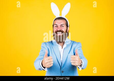 Getting ready for this. celebrating easter in springtime. funny man in rabbit costume. happy easter. man imagine he is rabbit. male wear bunny ears. just having fun. Easter Holiday Greeting. Stock Photo