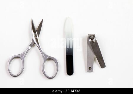 Scissors and other instruments for nails on the white background Stock Photo
