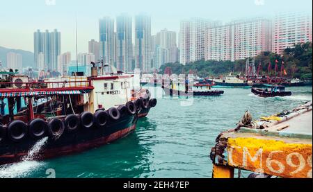 Hong Kong, China.  Aberdeen harbour. Fishing boats and highrise apartment blocks. Stock Photo