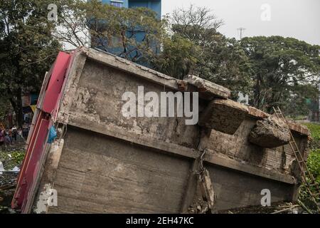 A view of a three-storey building that collapsed and tumbled into a swamp at Modhya Charail in city's Keraniganj area on a Friday morning.A three-storey building collapsed and tumbled into a swamp at Modhya Charail in city's Keraniganj area on Friday morning. The building came crashing down around 8:20am trapping seven people inside. Later Fire Service and Civil Defence members rushed to the scene and rescued them and sent them to Mitford Hospital. Stock Photo