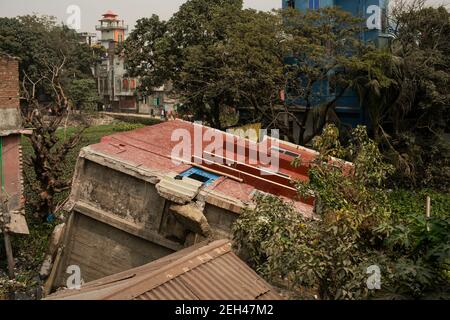 A view of a three-storey building that collapsed and tumbled into a swamp at Modhya Charail in city's Keraniganj area on a Friday morning.A three-storey building collapsed and tumbled into a swamp at Modhya Charail in city's Keraniganj area on Friday morning. The building came crashing down around 8:20am trapping seven people inside. Later Fire Service and Civil Defence members rushed to the scene and rescued them and sent them to Mitford Hospital. Stock Photo