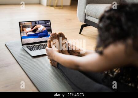 Online Laptop Home Fitness Workout And Exercise Stock Photo