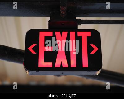 Image of a red emergency exit sign. Stock Photo