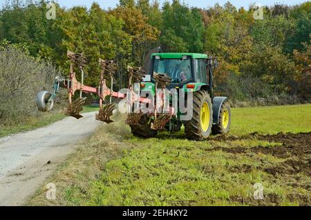 Austria, farmer plowing field with tractor Stock Photo