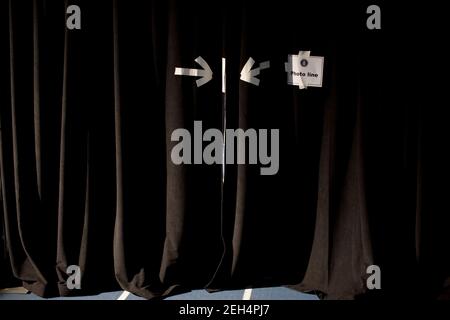 A sign is taped to a black curtain backstage at the Rothman Center at Fairleigh Dickinson University in Teaneck, N.J., prior to a rally for New Jersey Gov. Jon Corzine, Oct. 21, 2009. Stock Photo