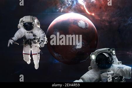 Mars. Astronauts in front of the inhabited red planet. Solar system. 3D render Stock Photo
