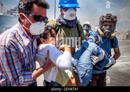 Michael Bunel / Le Pictorium -  Turkey, Gezi park conflict -  11/06/2013  -  Turkey / Istanbul  -  Demonstrators evacuate a woman caught in massive tear gas fire by law enforcement in Taksim Square. That same morning, the square was stormed by law enforcement and violent clashes erupted until the evening. June 11, 2013. Istanbul. Turkey. Stock Photo