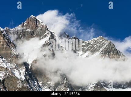 top of Lhotse and Nuptse with clouds on the top - way to mount Everest base camp, Khumbu valley, Sagarmatha national park, Nepalese Himalayas Stock Photo