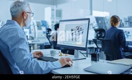 Modern Industrial Factory: Team of Mechanical Engineers Working on Computers, Using Newest High-Tech Devices Like Virtual Reality Headsets to Design Stock Photo