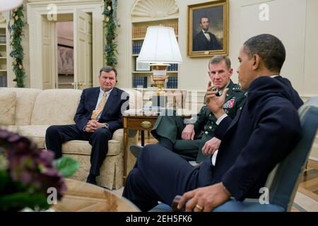 President Barack Obama meets with United States Ambassador to Afghanistan Karl Eikenberry, left, and  General Stanley McChrystal, Commander of U.S. Forces in Afghanistan, in the Oval Office, Dec. 7, 2009. Stock Photo