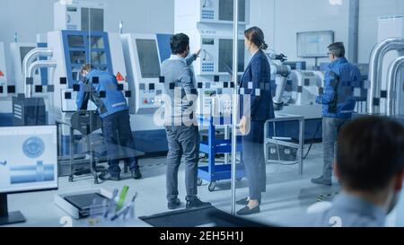Modern Factory Office: Team of Industrial Engineers Working on Computers. In Factory Workshop: Professional Workers Use High-Tech Industrial CNC Stock Photo