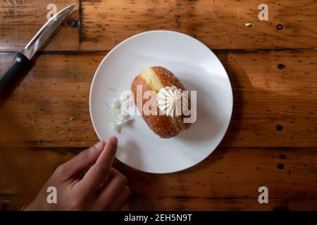Delicious doughnut donut baking handmade dessert cream sugar craving food photography aesthetic dark background floral sweet eating temptation sweet Stock Photo