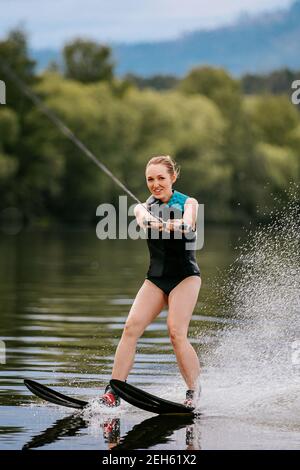 young woman on water ski in summer lake Stock Photo