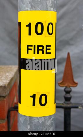 Yellow H fire hydrant location sign on a lamp post showing diameter of ...