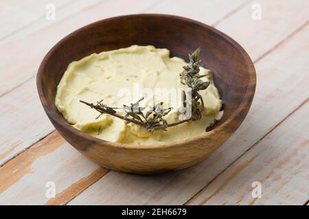 Freshly made vegan mustard on a wooden bowl Stock Photo