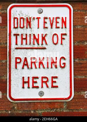A Don't Even Think of Parking Here sign in a garage driveway in a residential area in Hellesdon, Norfolk, England, United Kingdom. Stock Photo