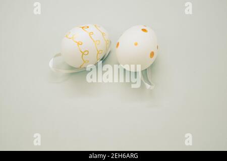 Easter eggs colored with golden paint in different patterns isolated on a white background Stock Photo