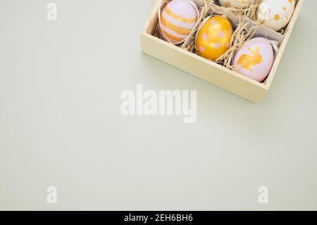 Closeup shot of easter eggs colored with golden paint in different patterns in a box Stock Photo