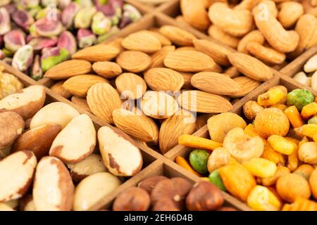 The heap of various nuts in the wooden box. Stock Photo
