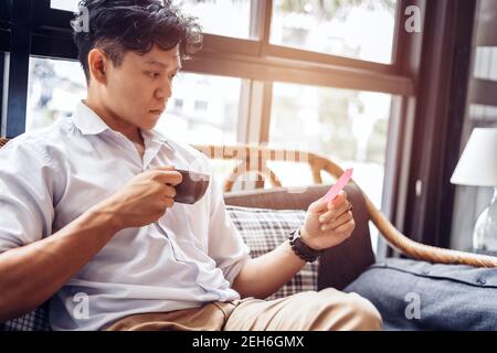 Businessman hold and read sticky note. Stock Photo