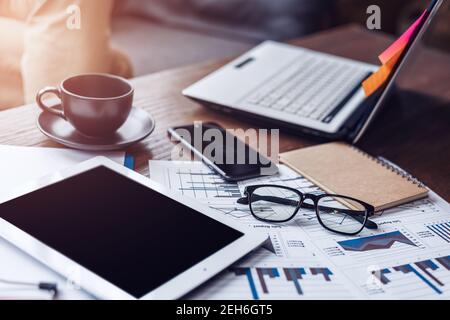 Glasses, book, paper graph and tablet on the table. Object of business concept. Stock Photo