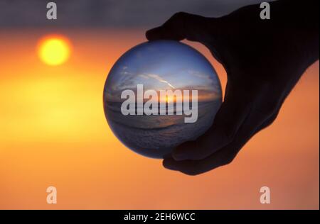 Beautiful sunset captured through a lens ball at Madeira Beach, Florida, U.S Stock Photo