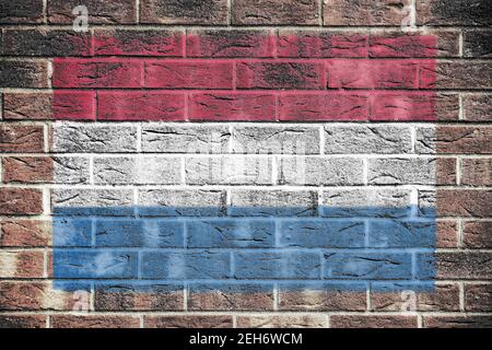 Netherlands flag on old brick wall background Stock Photo
