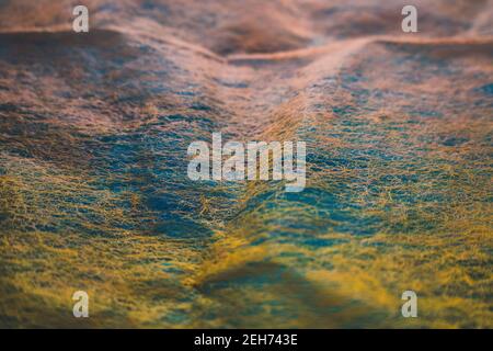 coral and orange transparent netted fabric over colored blue wood Stock Photo