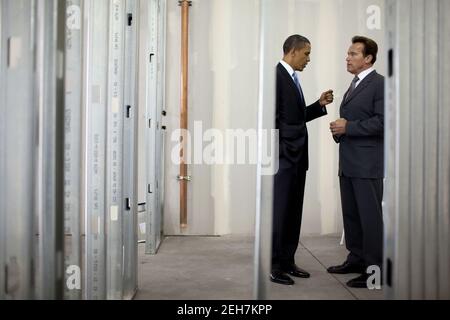 President Barack Obama talks with California Gov. Arnold Schwarzenegger before an event at Solyndra, Inc., in Fremont, Calif., May 26, 2010. Stock Photo
