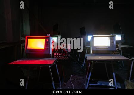 Old broken Soviet computers in abandoned computer hall. Stock Photo