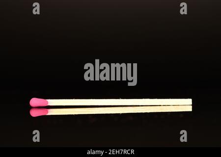 One wooden match, close-up, on a black background. Stock Photo