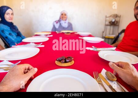 Arabic family sitting waiting for iftar food Stock Photo