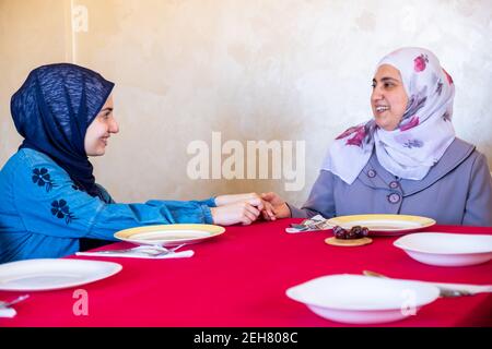 Arabic family sitting waiting for iftar food Stock Photo