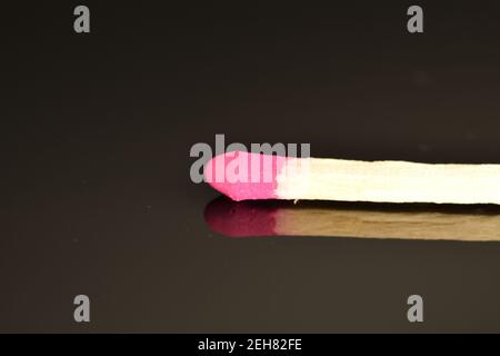 One wooden match, close-up, on a black background. Stock Photo
