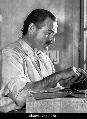 Ernest Hemingway. Portrait of the American writer, Ernest Miller Hemingway (1899-1961) at his typewriter in 1939. Stock Photo