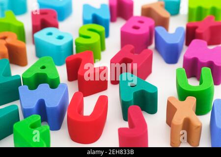 Polymer clay letters scattered on a table. Close up. Stock Photo