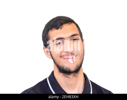 Isolated Arabic guy holding flower in his mouth Stock Photo