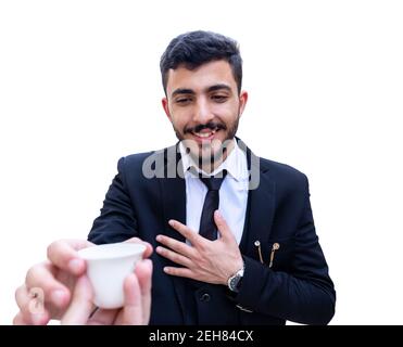 Arabian man wearing suit and holding a cup of arabic coffee Stock Photo