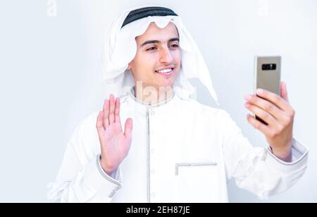 Arabic young man having online video call with his friends Stock Photo